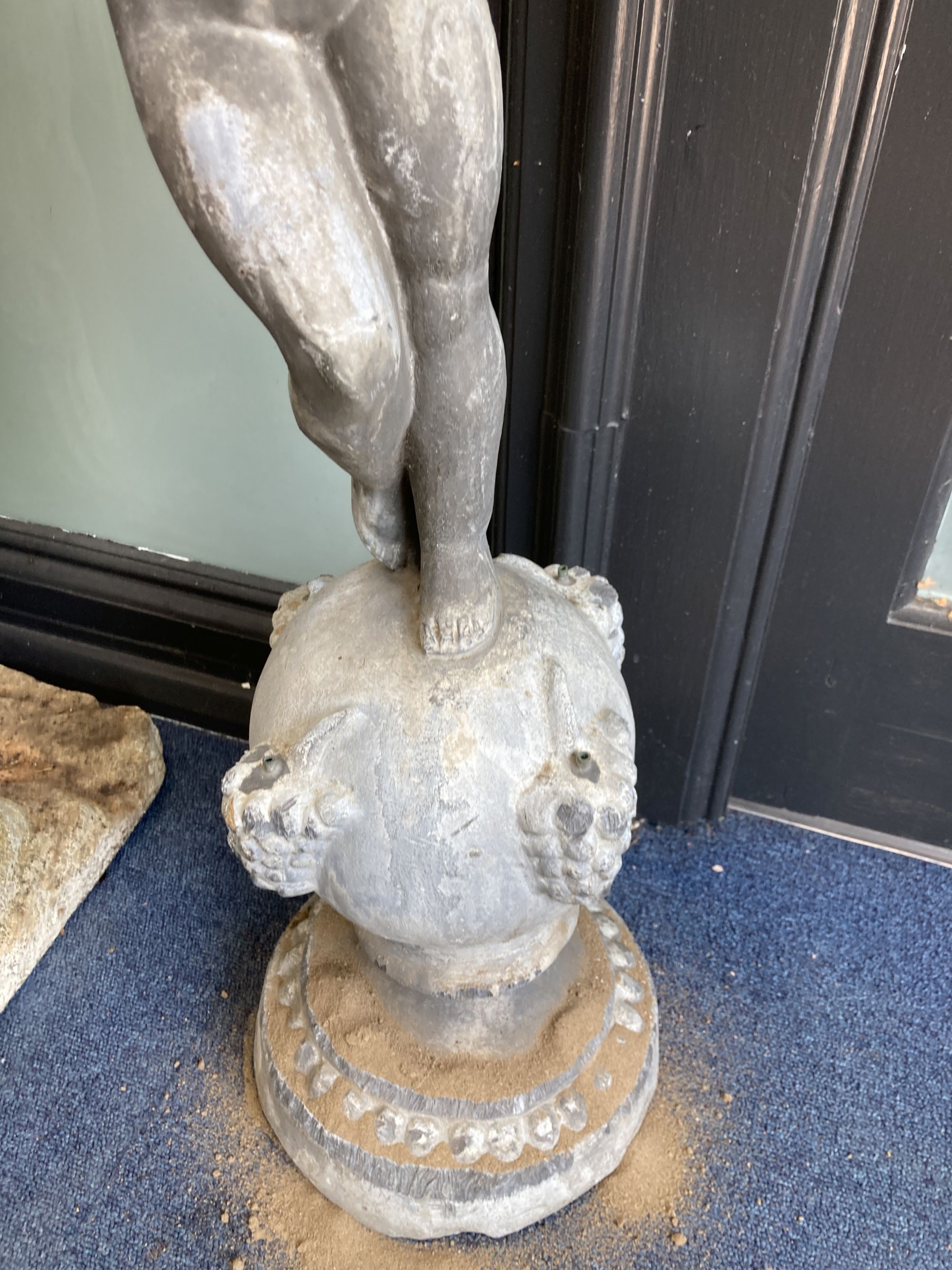 A Victorian lead garden ornament of a putto on orb, height 80cm